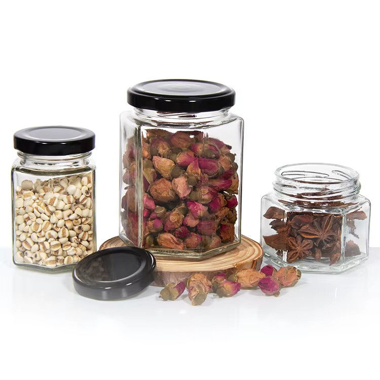 Υψηλής ποιότητας 2oz 3oz Διαφανή στρογγυλή διαφανή γυάλινα βάζα με μέλι για μέλι με χρωματικά καπάκια