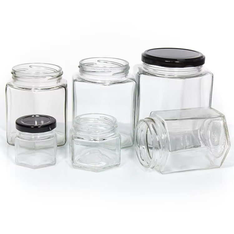 Υψηλής ποιότητας 2oz 3oz Διαφανή στρογγυλή διαφανή γυάλινα βάζα με μέλι για μέλι με χρωματικά καπάκια